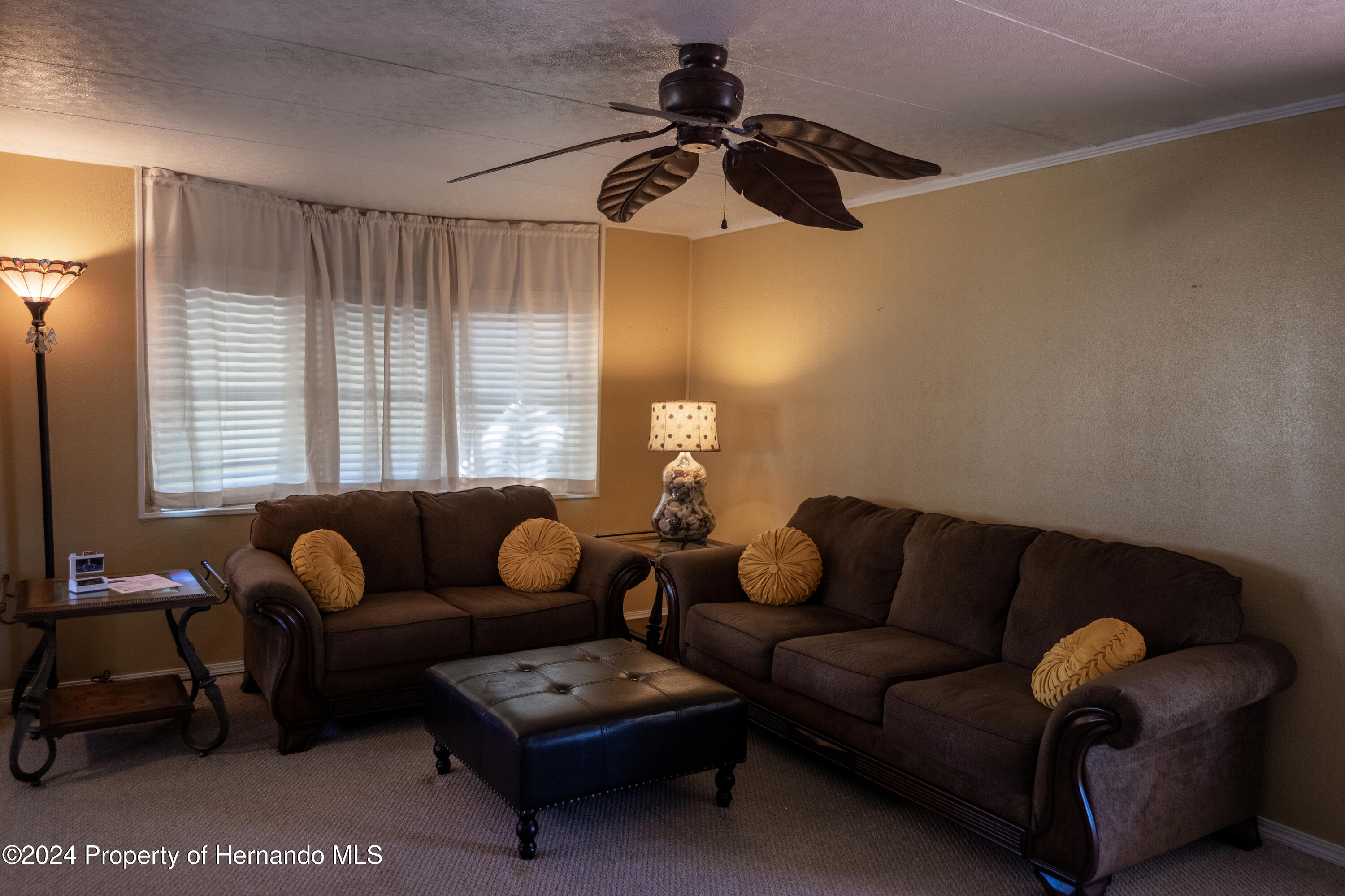 7526 Highpoint Boulevard Brooksville, FL 34613 - Photo 15 of 30 a living room with furniture and a window
