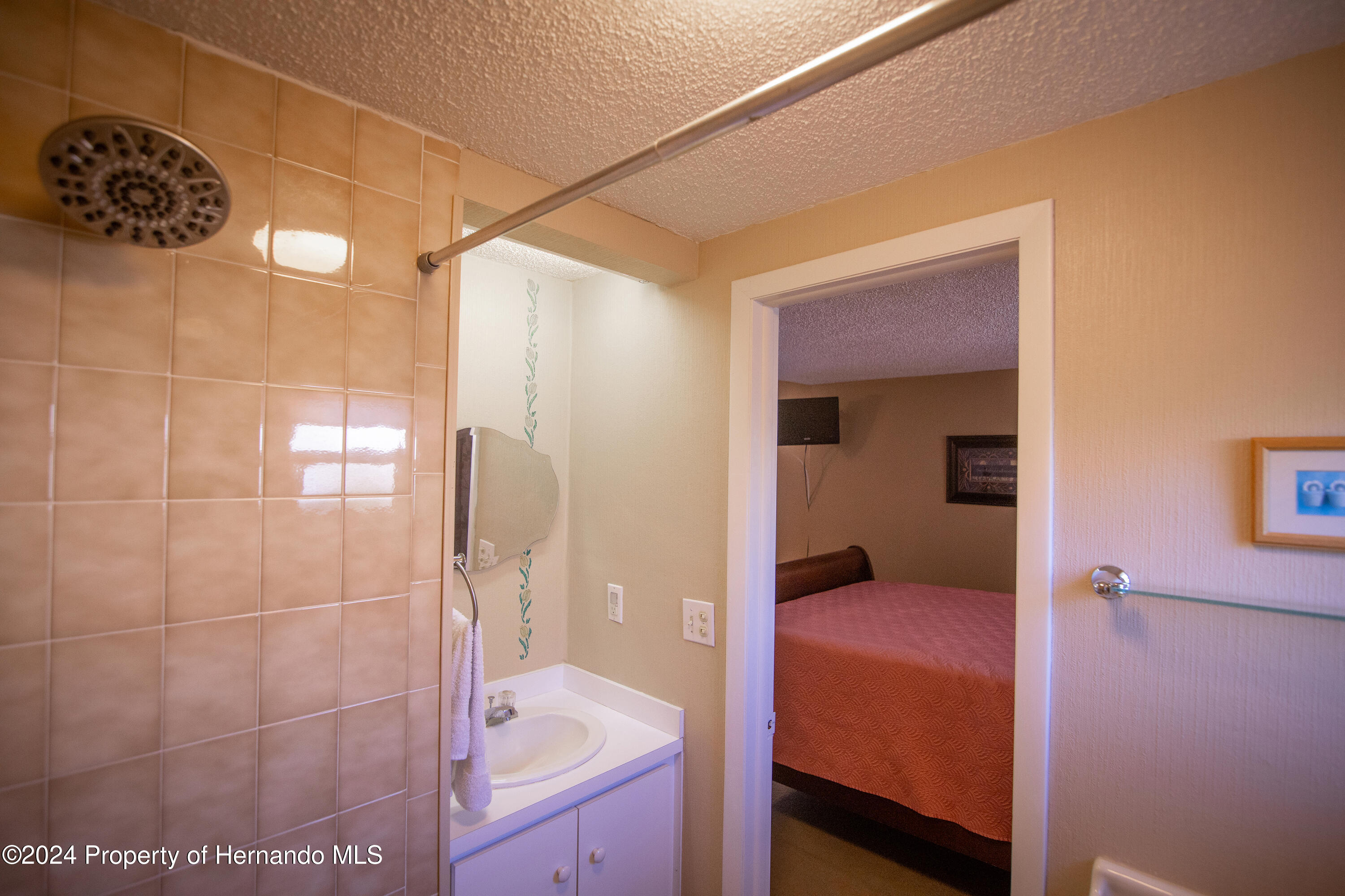 7526 Highpoint Boulevard Brooksville, FL 34613 - Photo 19 of 30 a bathroom with a tub and shower