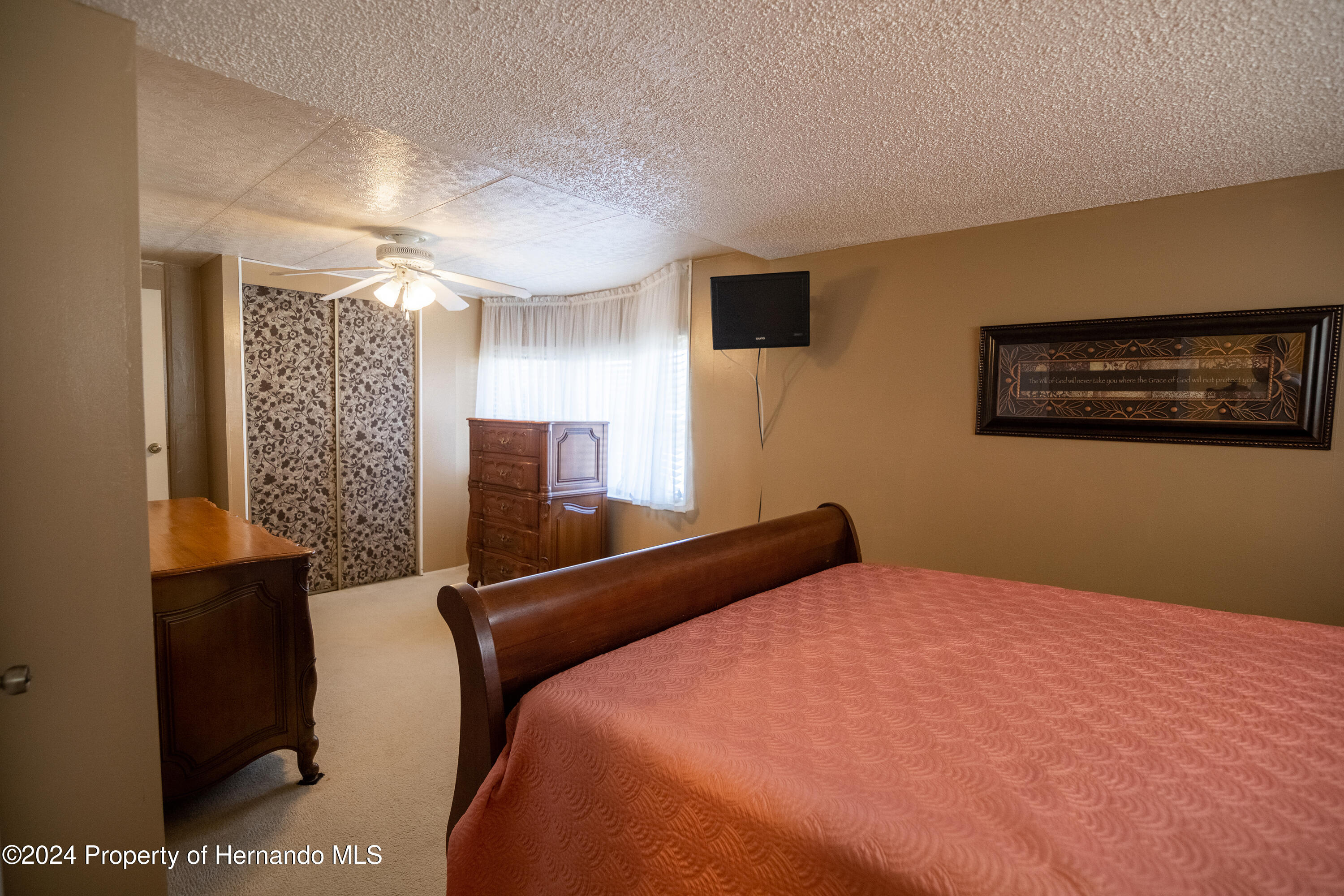 7526 Highpoint Boulevard Brooksville, FL 34613 - Photo 20 of 30 a bedroom with a bed and a view of bathroom