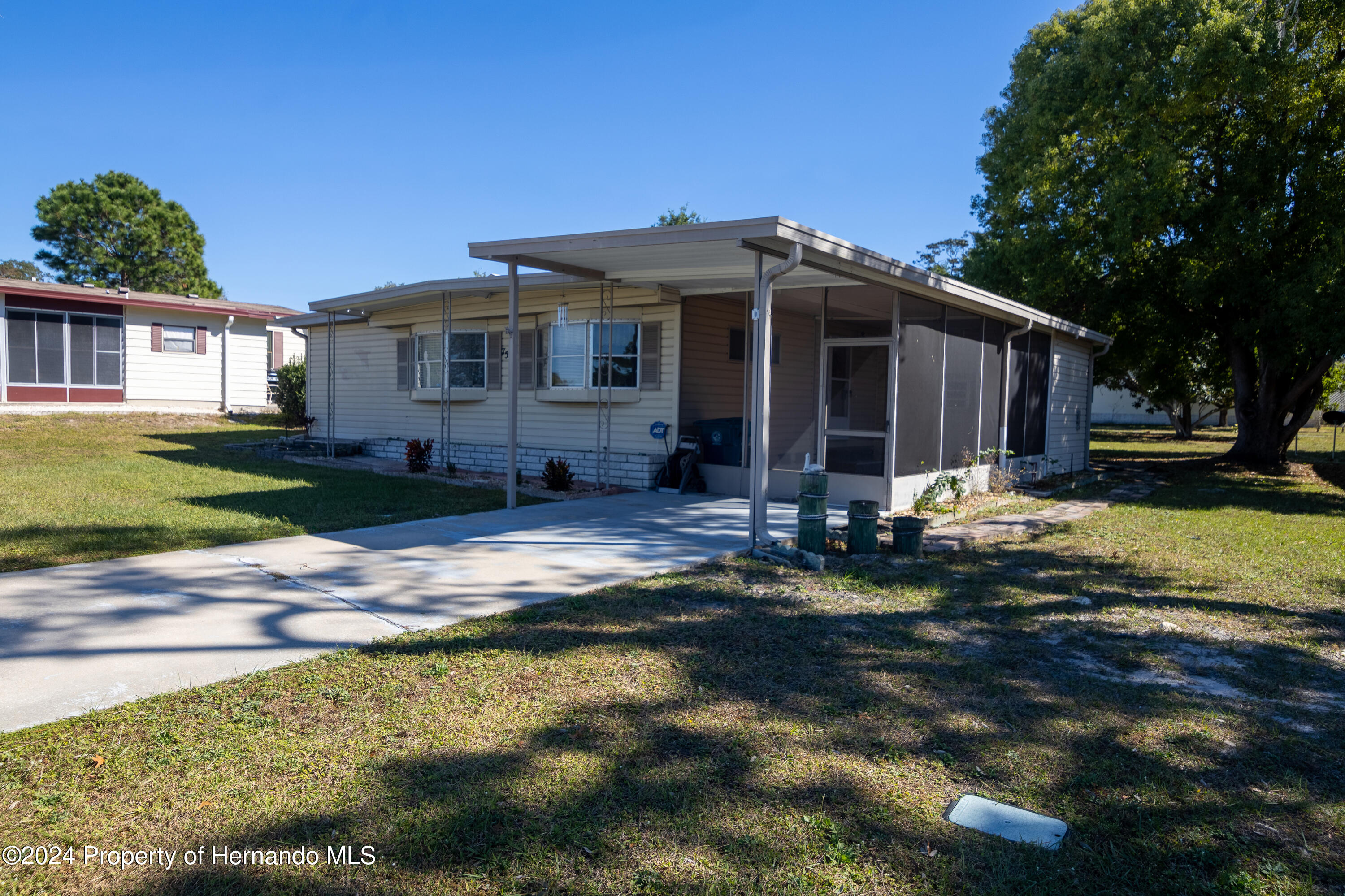 7526 Highpoint Boulevard Brooksville, FL 34613 - Photo 2 of 30 a front view of a house with a yard