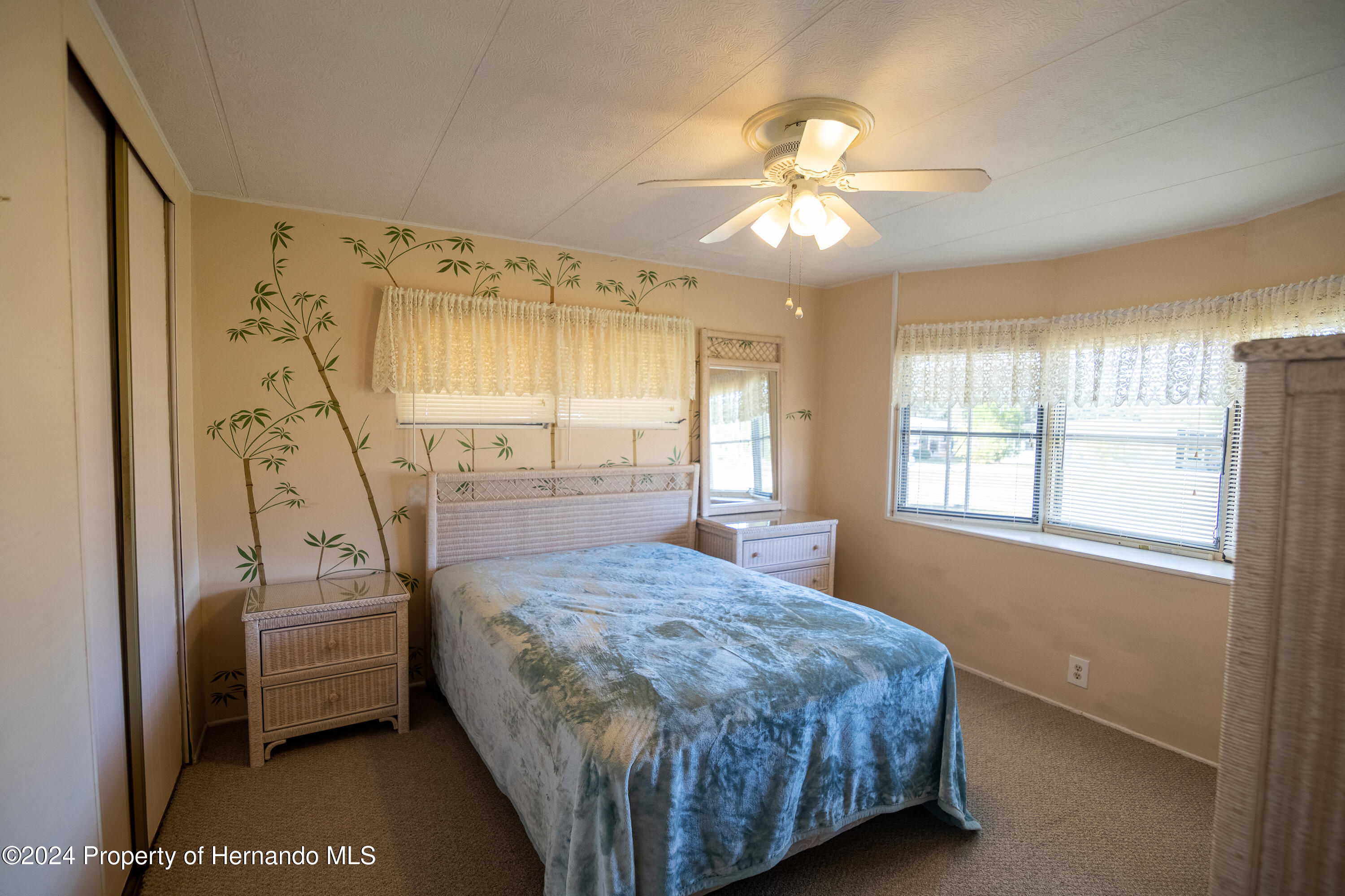 7526 Highpoint Boulevard Brooksville, FL 34613 - Photo 23 of 30 a bedroom with a bed and a window