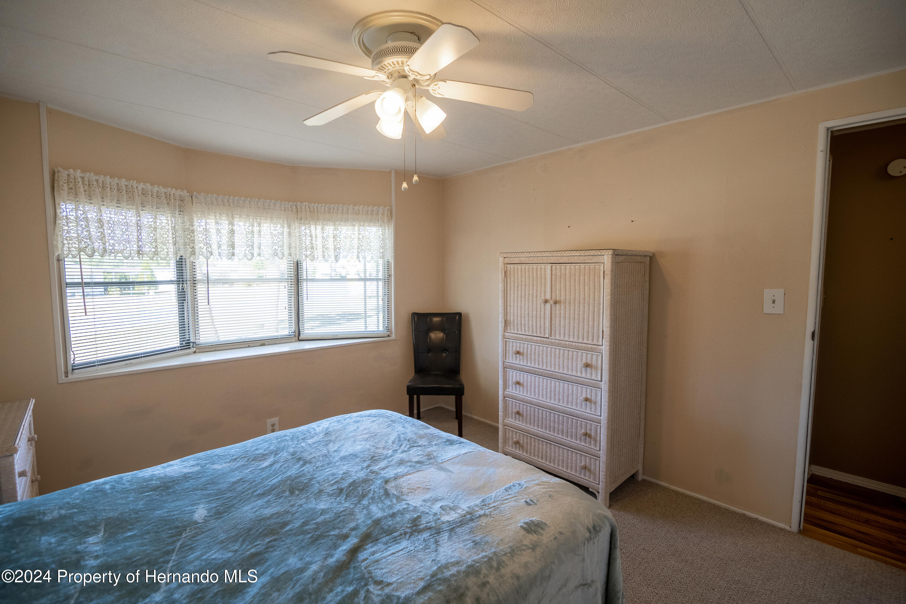 7526 Highpoint Boulevard Brooksville, FL 34613 - Photo 24 of 30 a bedroom with a bed and a window