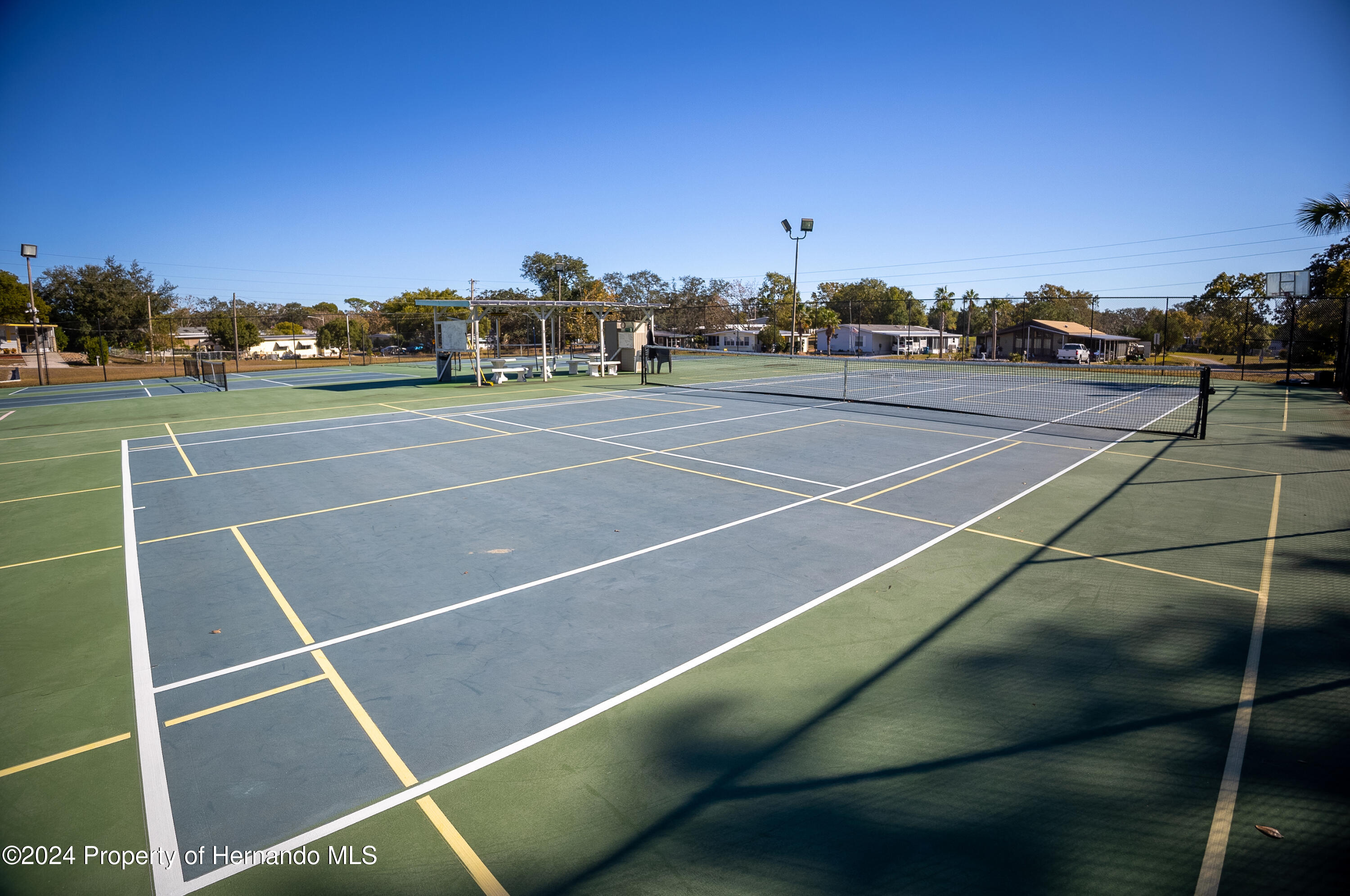 7526 Highpoint Boulevard Brooksville, FL 34613 - Photo 28 of 30 a view of an outdoor space and tennis court