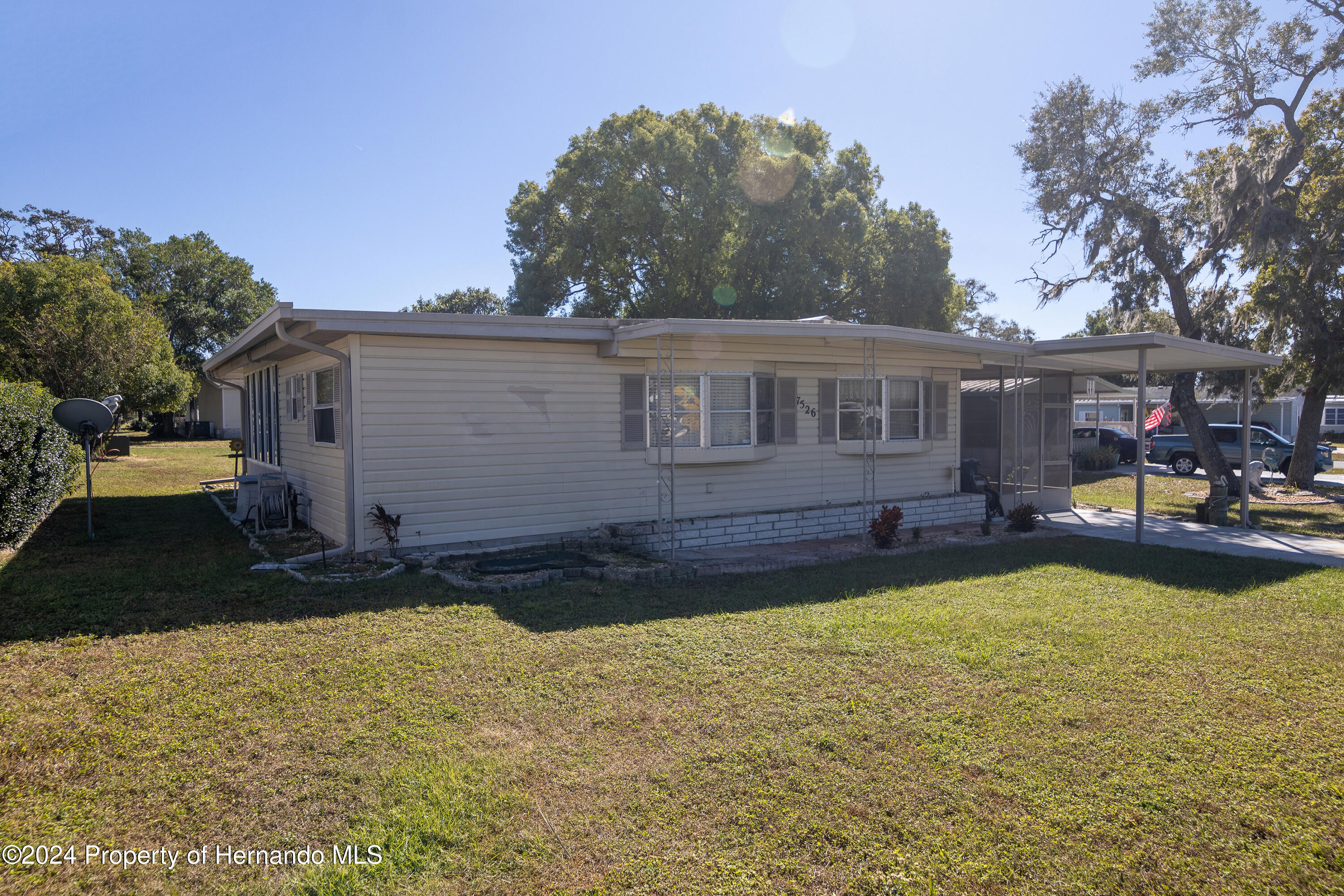 7526 Highpoint Boulevard Brooksville, FL 34613 - Photo 3 of 30 a view of a house with swimming pool and sitting area