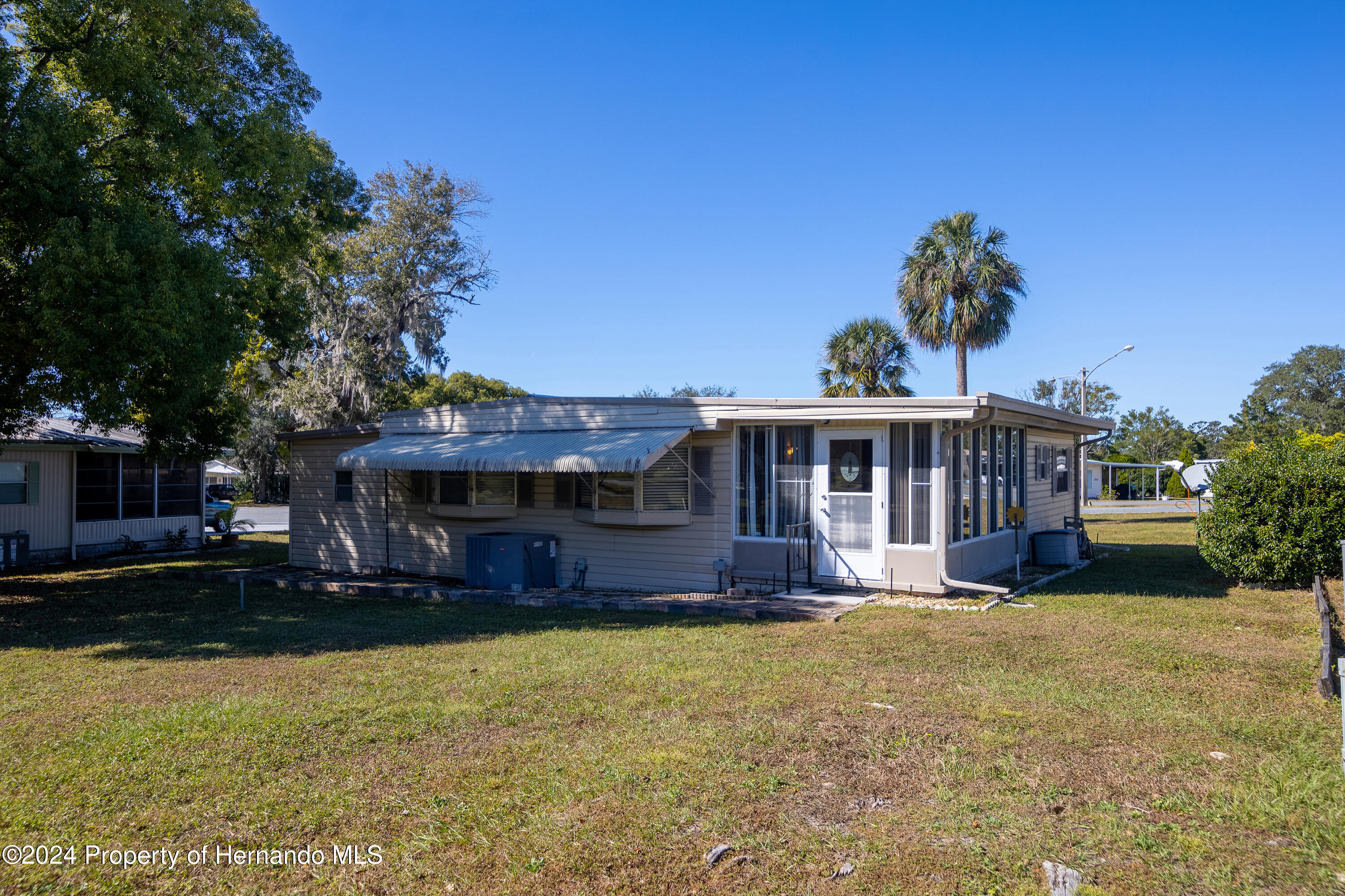 7526 Highpoint Boulevard Brooksville, FL 34613 - Photo 4 of 30 a front view of a house with a yard