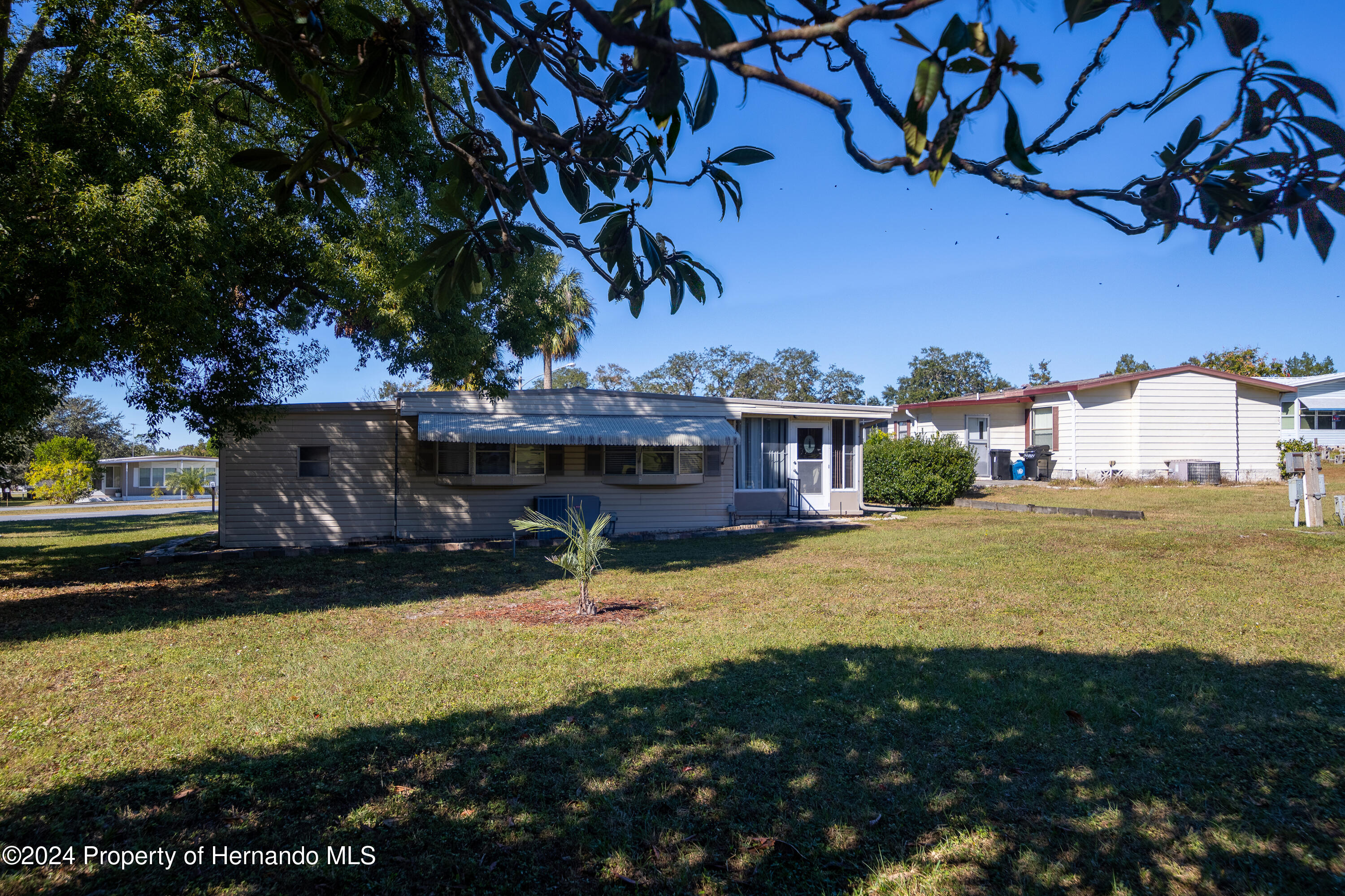 7526 Highpoint Boulevard Brooksville, FL 34613 - Photo 5 of 30 a view of a house with a yard