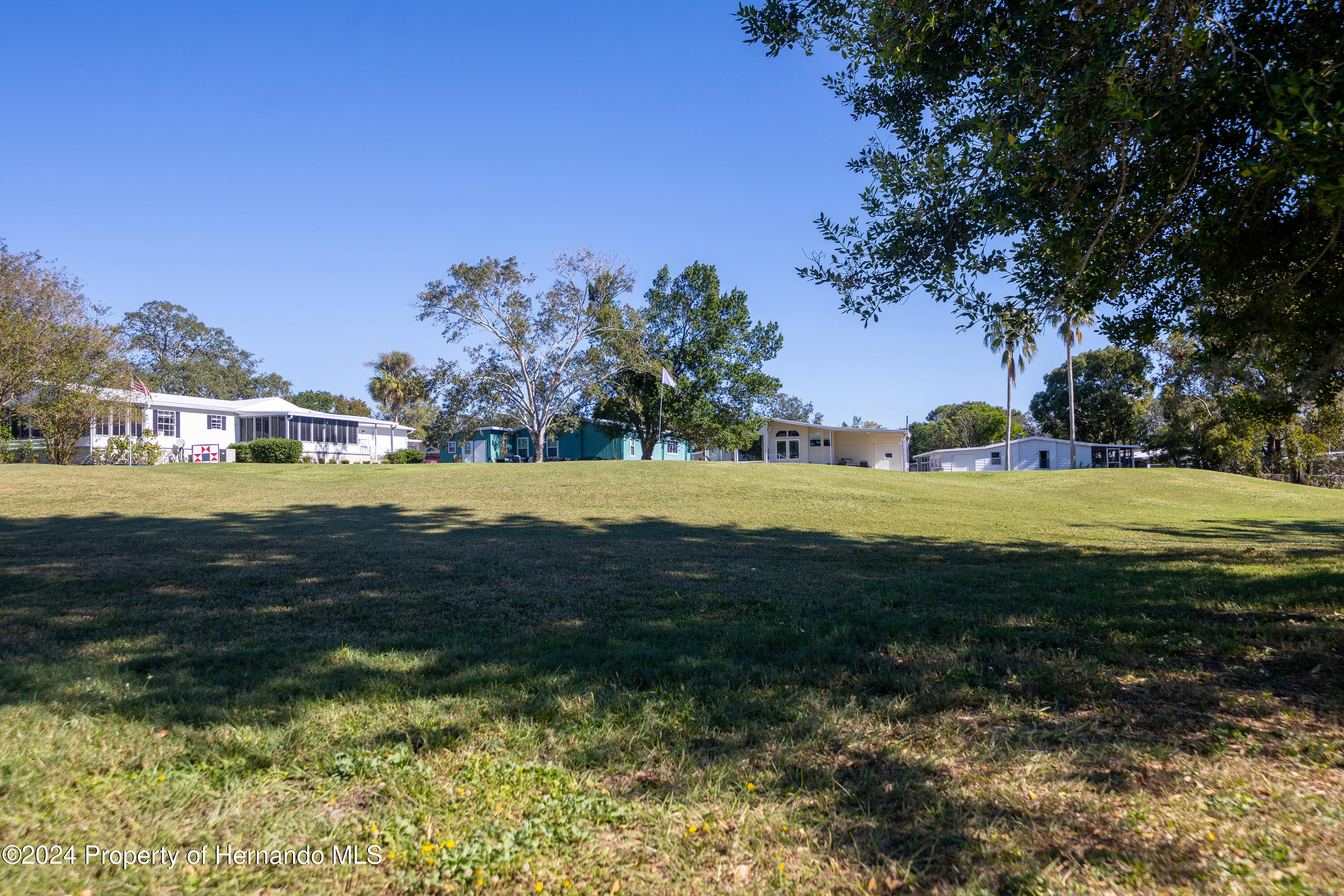 7526 Highpoint Boulevard Brooksville, FL 34613 - Photo 6 of 30 a view of a lake with a house in the background