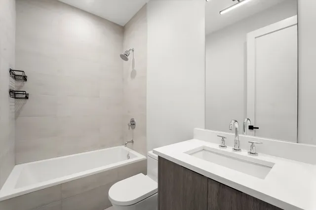 a bathroom with a sink a toilet and bathtub