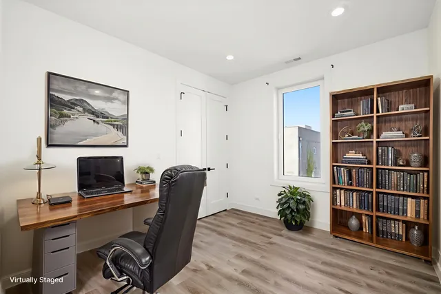 a view of a workspace with furniture and wooden floor