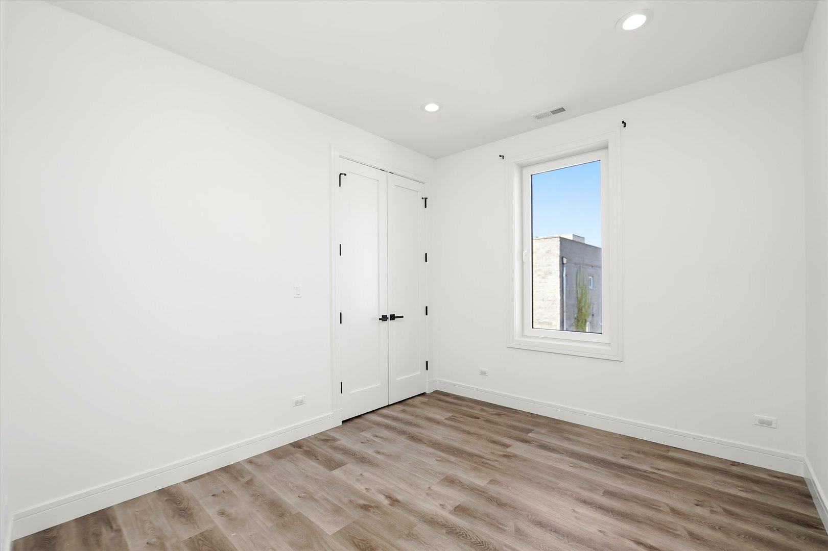 117 South Bell Avenue, Unit 4N Chicago, IL 60612 - Photo 13 of 30 an empty room with wooden floor and windows