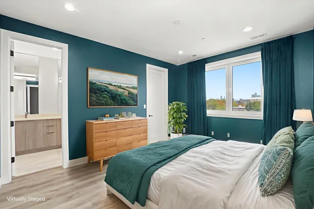 a bedroom with a bed and a dresser