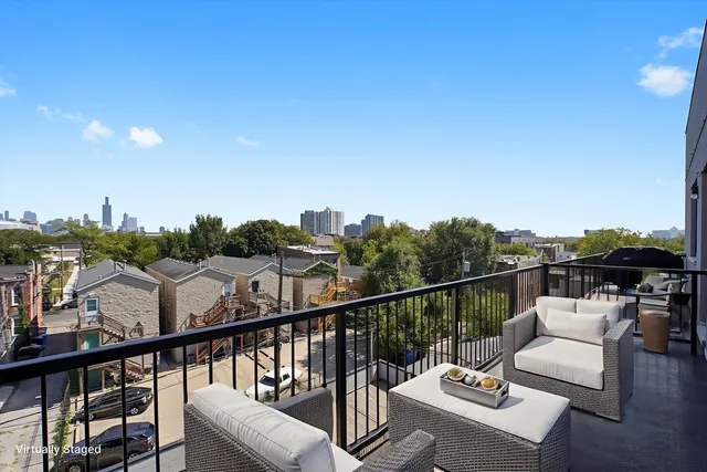 a view of a balcony with couches and wooden floor