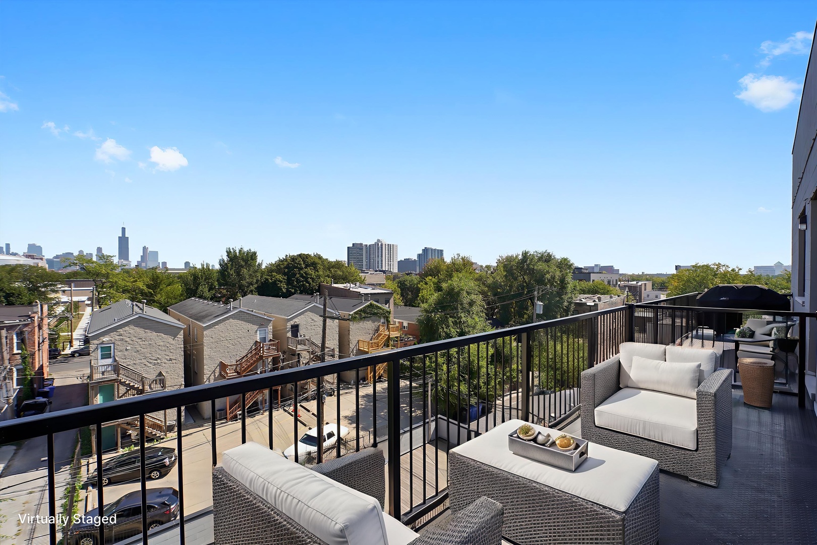 117 South Bell Avenue, Unit 4N Chicago, IL 60612 - Photo 21 of 30 a view of a balcony with couches and wooden floor