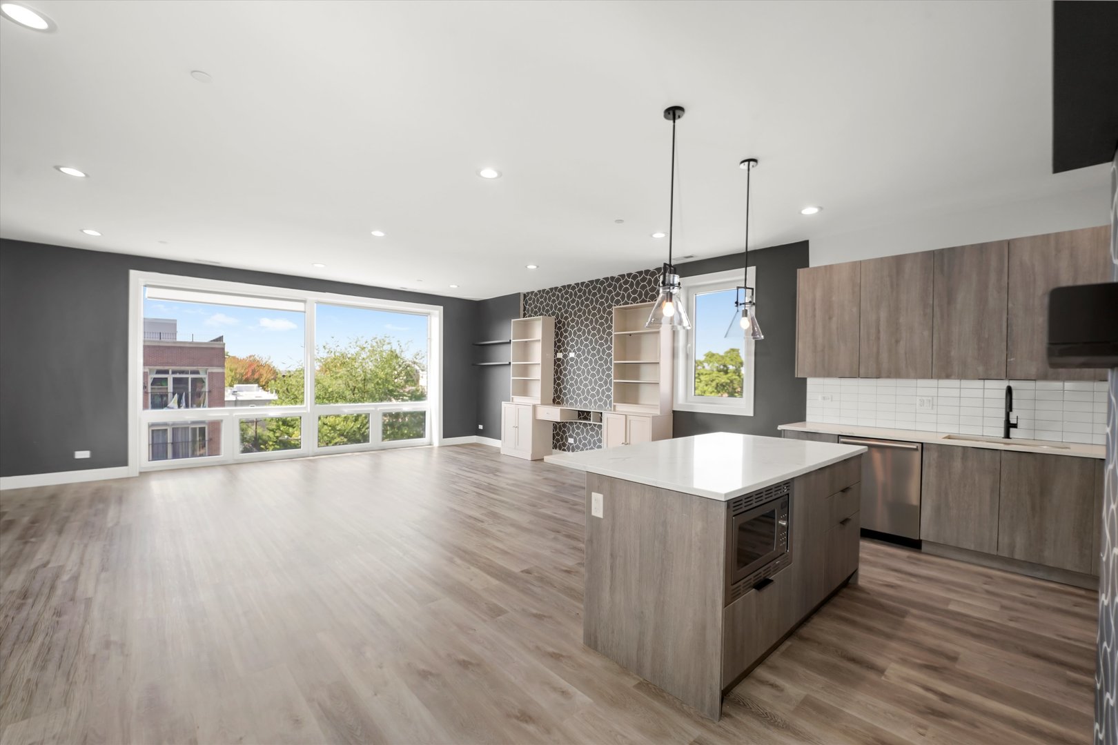 117 South Bell Avenue, Unit 4N Chicago, IL 60612 - Photo 5 of 30 a kitchen with stainless steel appliances granite countertop a sink a stove and a large window