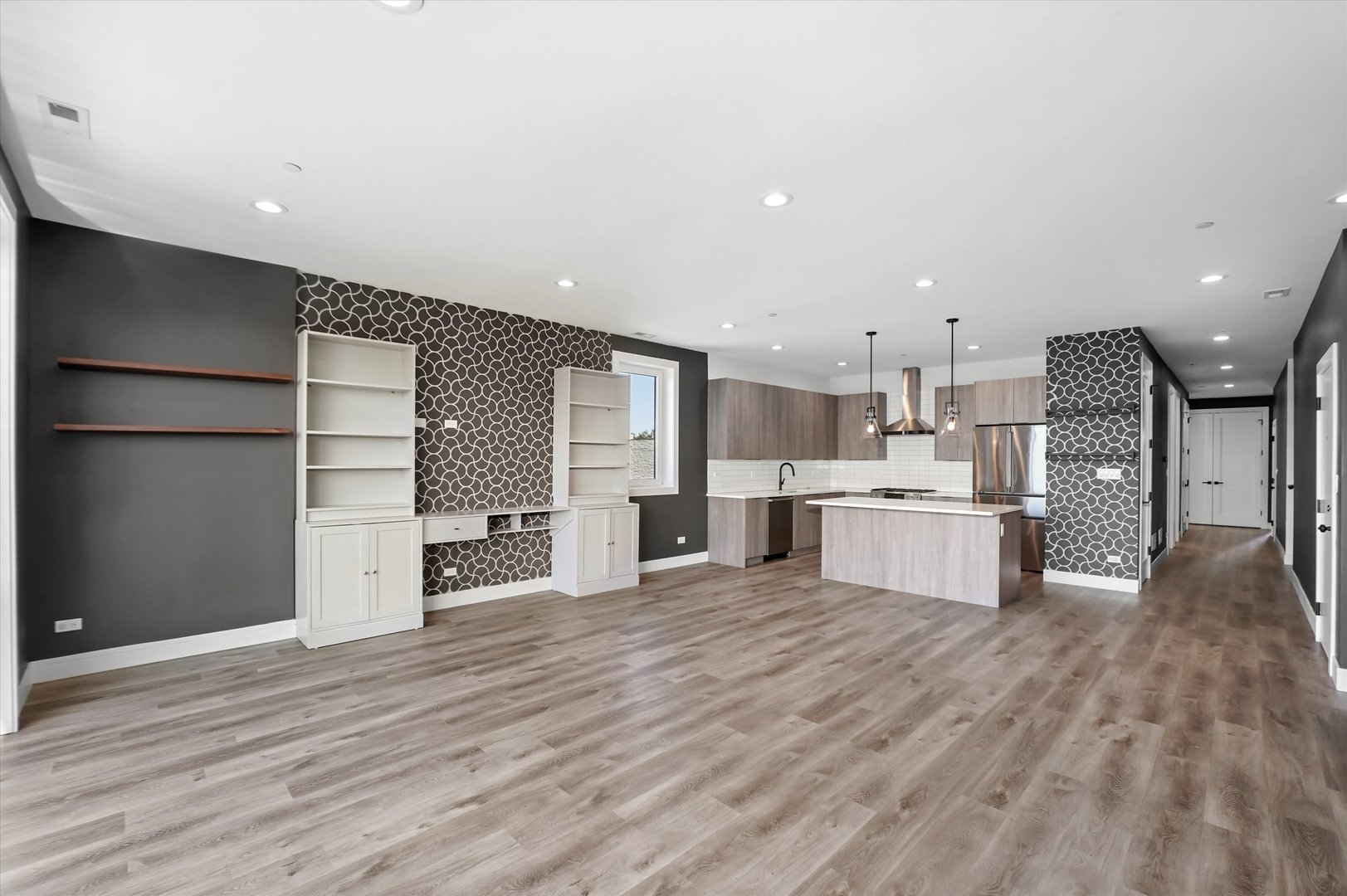 117 South Bell Avenue, Unit 4N Chicago, IL 60612 - Photo 6 of 30 a large white kitchen with kitchen island a sink stainless steel appliances and cabinets