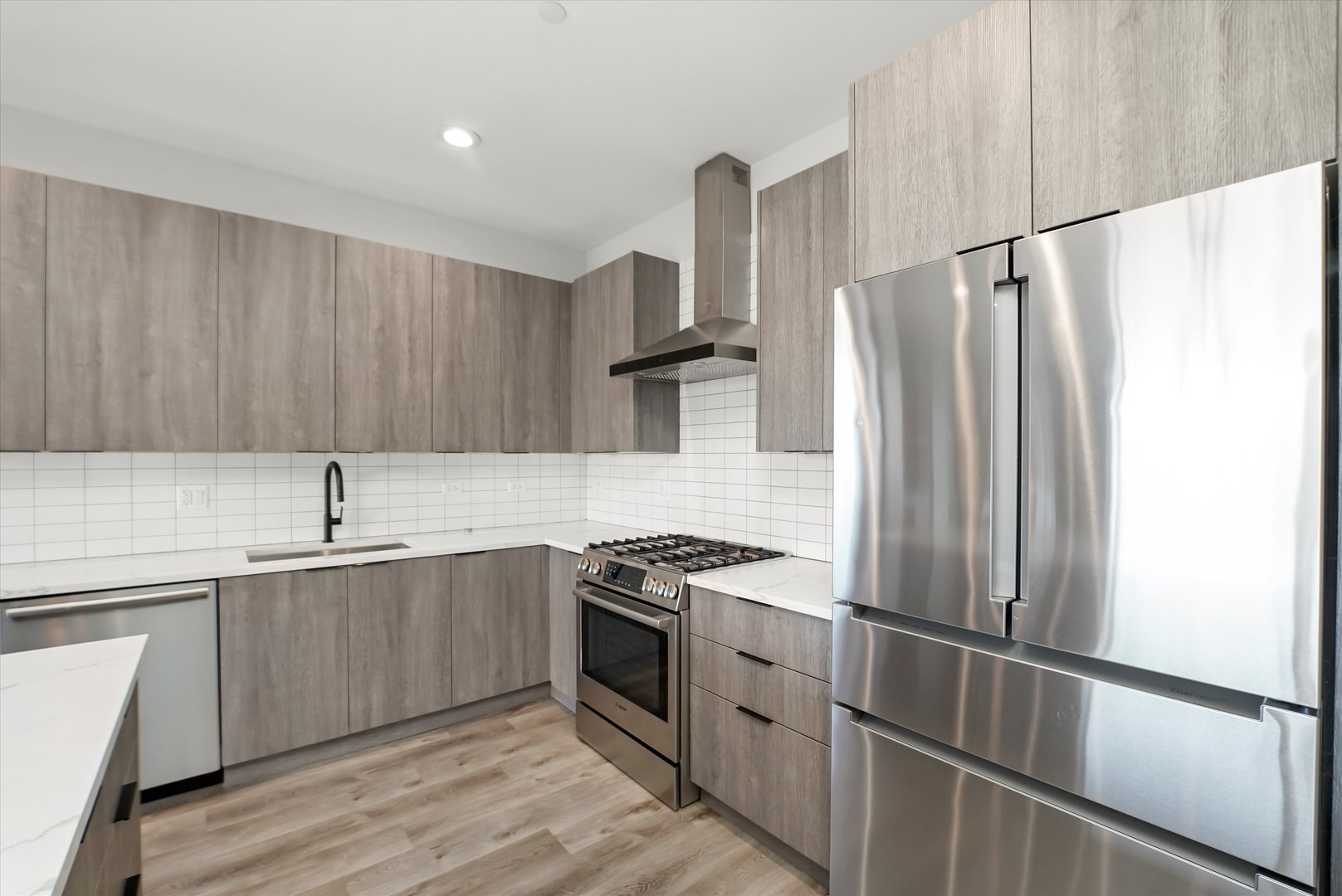 117 South Bell Avenue, Unit 4N Chicago, IL 60612 - Photo 8 of 30 a kitchen with stainless steel appliances granite countertop a refrigerator and a sink