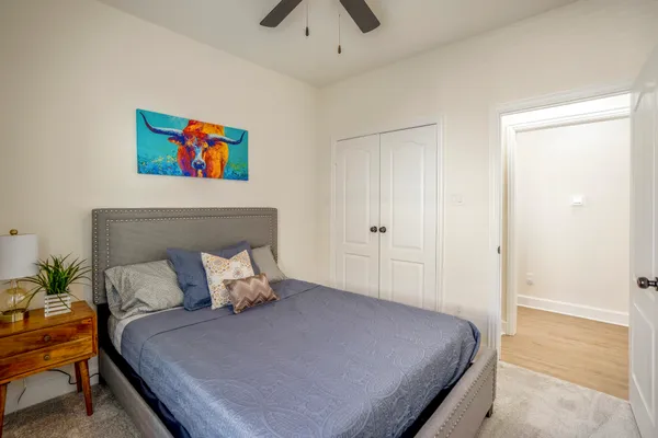 a bedroom with a bed and a chandelier