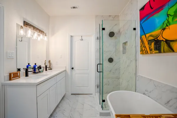 a bathroom with a sink mirror toilet and shower