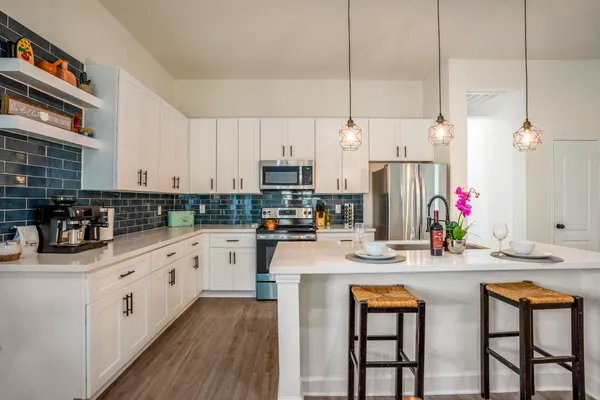 a kitchen with stainless steel appliances kitchen island granite countertop a sink and cabinets