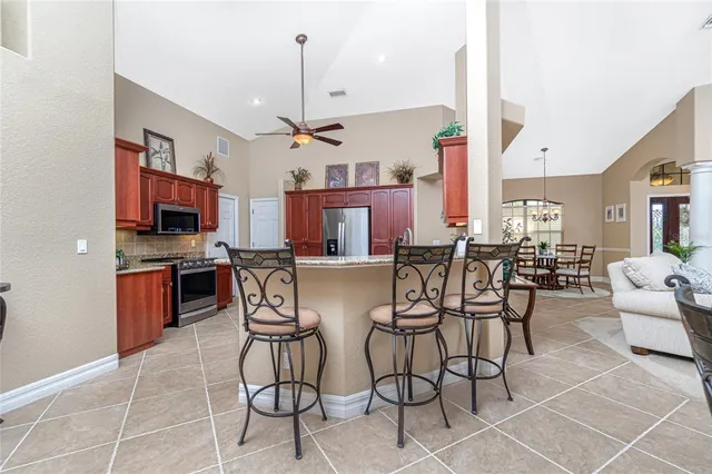 a living room with furniture a flat screen tv and a large window