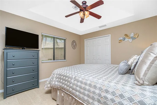 a living room with furniture a ceiling fan and a window
