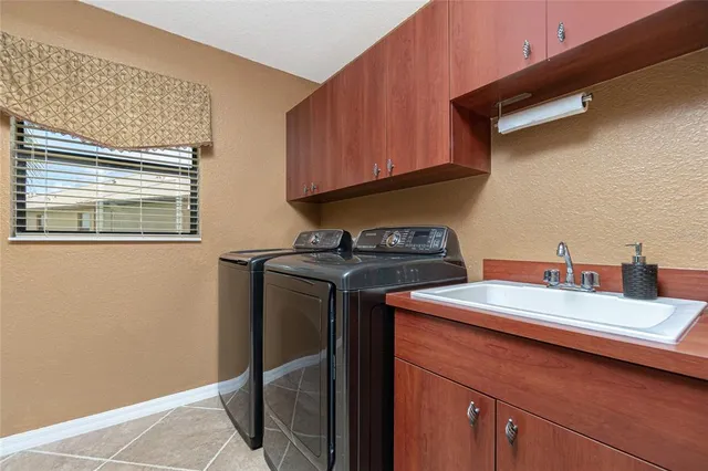 a view of a patio with a table and chairs under an umbrella