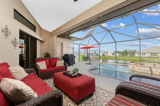 a view of a patio with a table and chairs under an umbrella