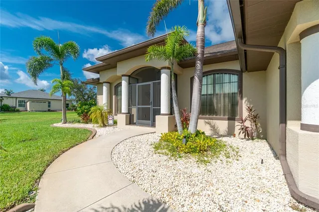 a living room with patio furniture and a large window