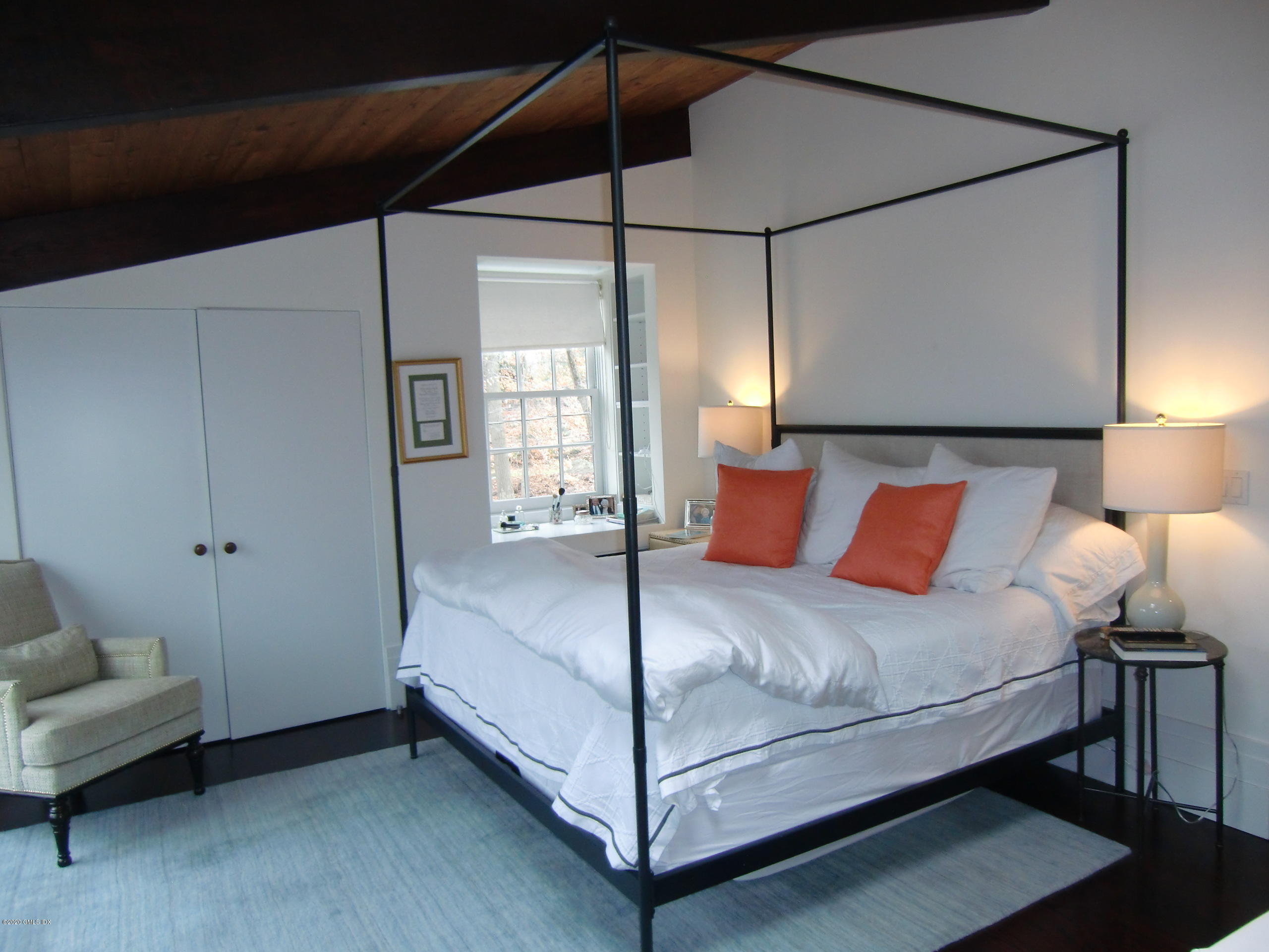 424 Cognewaugh Road Cos Cob, CT 06807 - Photo 11 of 27 a bedroom with a bed and a mirror