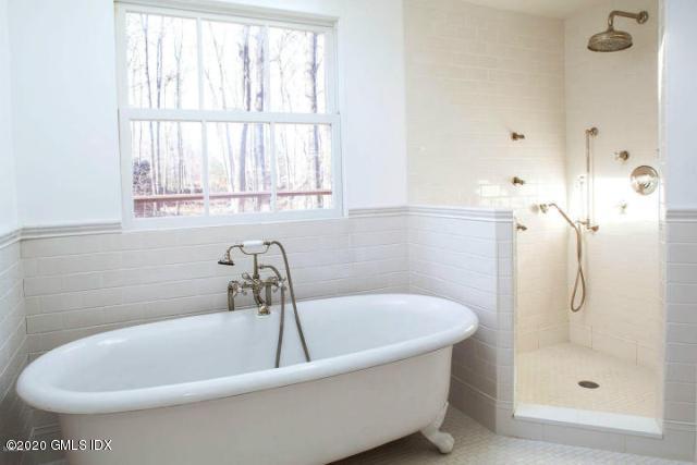 424 Cognewaugh Road Cos Cob, CT 06807 - Photo 12 of 27 a white bath tub sitting next to a shower