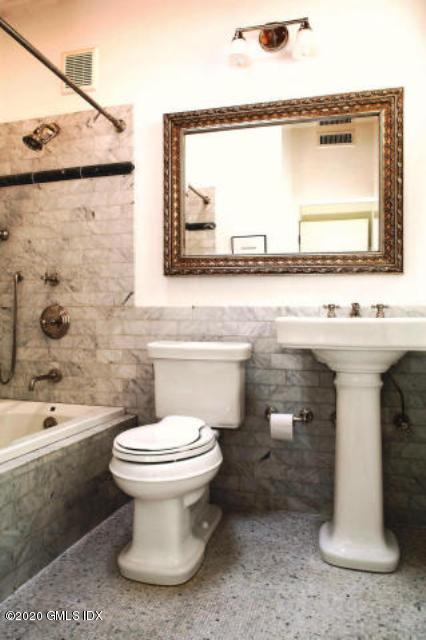 424 Cognewaugh Road Cos Cob, CT 06807 - Photo 14 of 27 a bathroom with a sink toilet and mirror