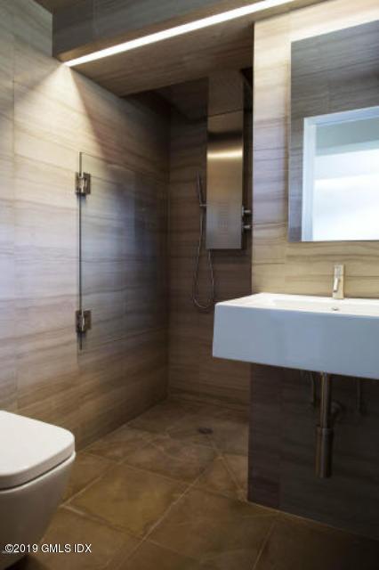 424 Cognewaugh Road Cos Cob, CT 06807 - Photo 20 of 27 a bathroom with a sink a toilet and shower