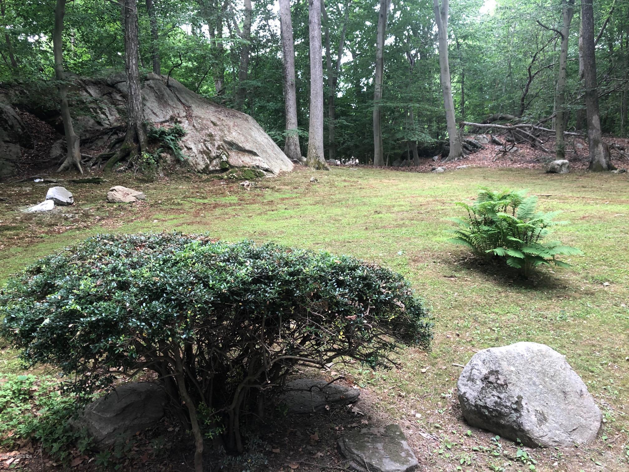 424 Cognewaugh Road Cos Cob, CT 06807 - Photo 26 of 27 a view of a backyard with plants and a patio