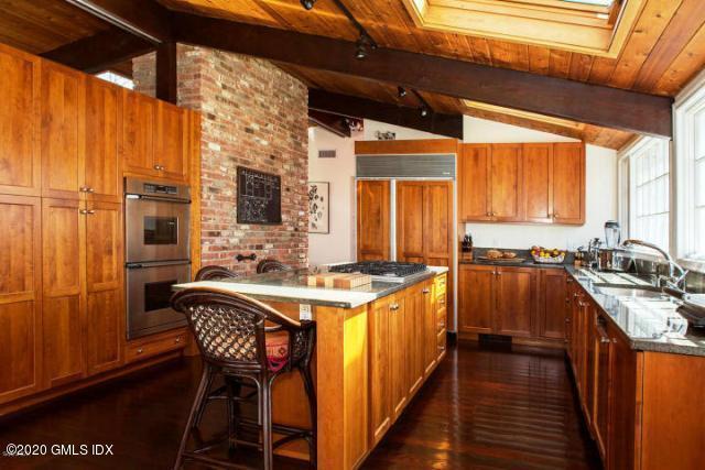 424 Cognewaugh Road Cos Cob, CT 06807 - Photo 8 of 27 a kitchen with stainless steel appliances granite countertop a stove a sink dishwasher and a refrigerator with wooden floor