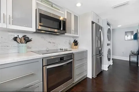 a kitchen with stainless steel appliances a stove microwave and sink