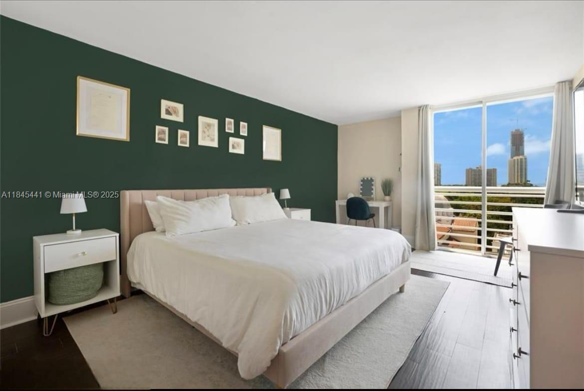 2400 Southwest 3rd Avenue, Unit 802 Miami, FL 33129 - Photo 6 of 11 a bedroom with a bed and lamp