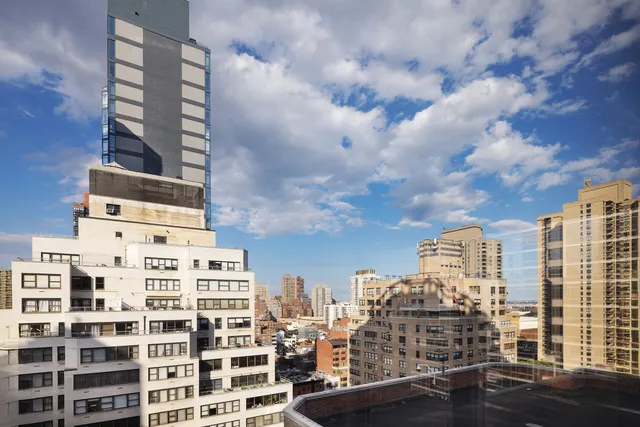 a dining room with furniture a chandelier and wooden floor
