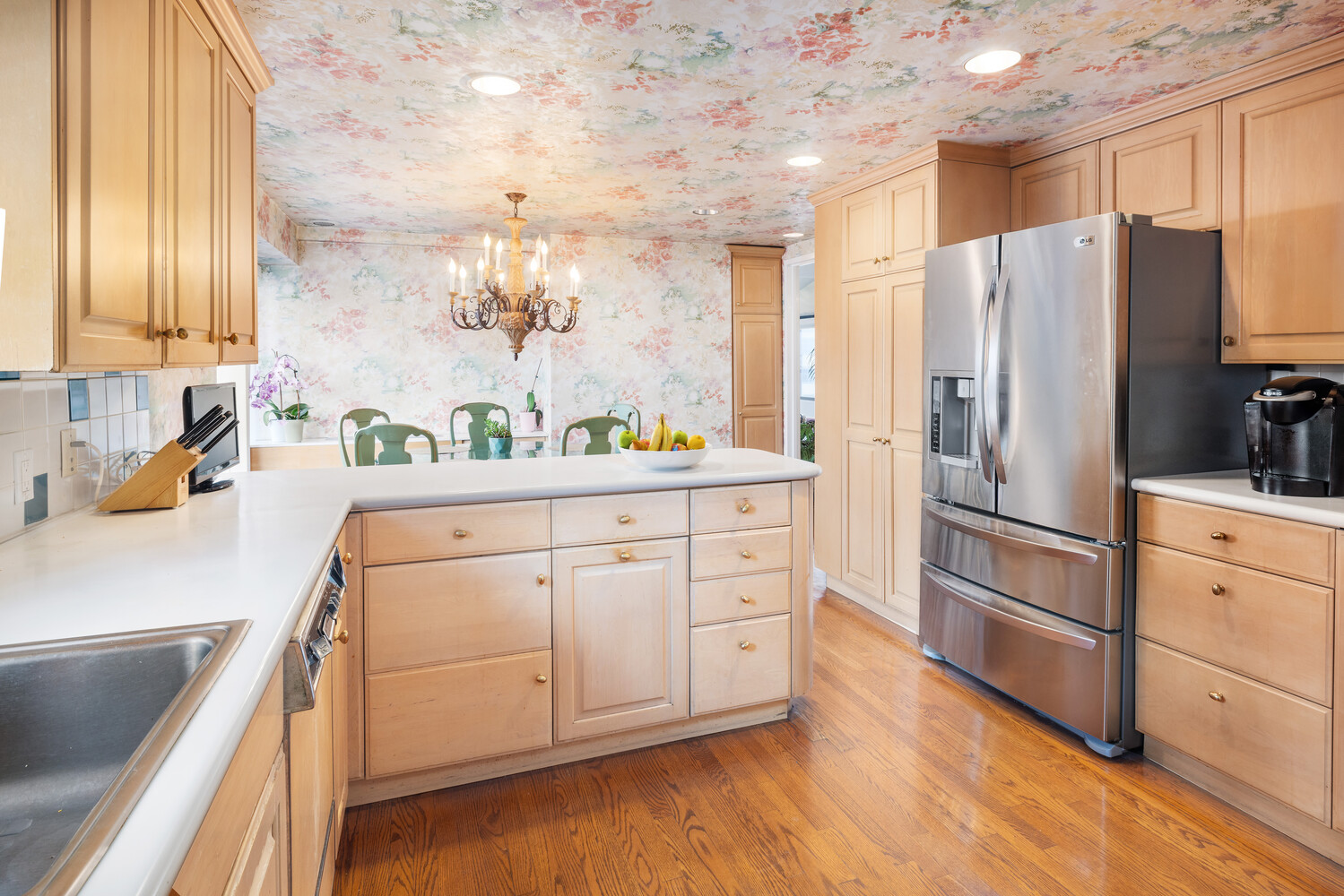 360 East 72nd Street, Unit C1803 Manhattan, NY 10021 - Photo 7 of 15 a kitchen with stainless steel appliances a refrigerator sink and cabinets