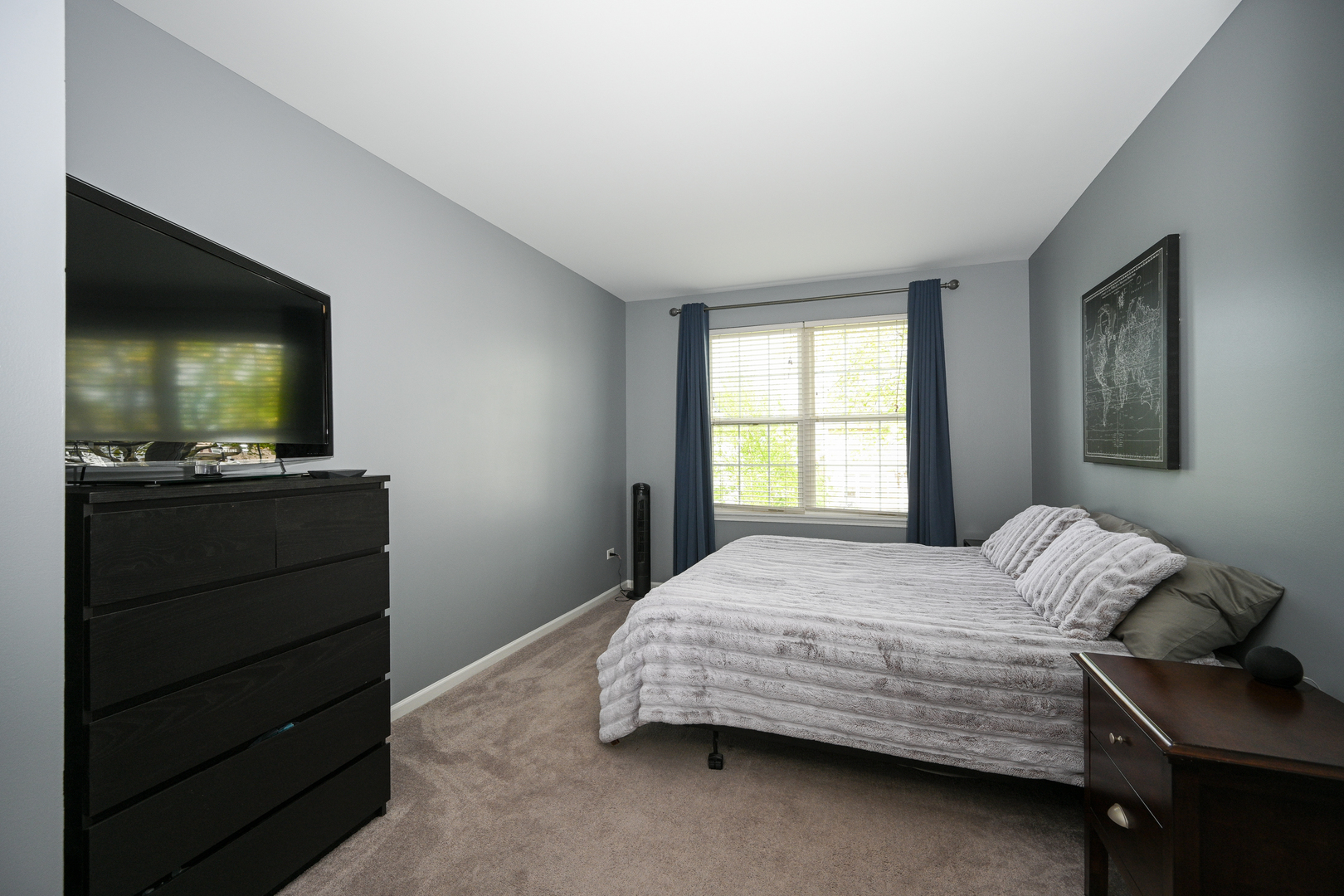 2333 Overlook Court, Unit 2333 Naperville, IL 60563 - Photo 11 of 24 a bedroom with a bed and a flat tv screen on dresser