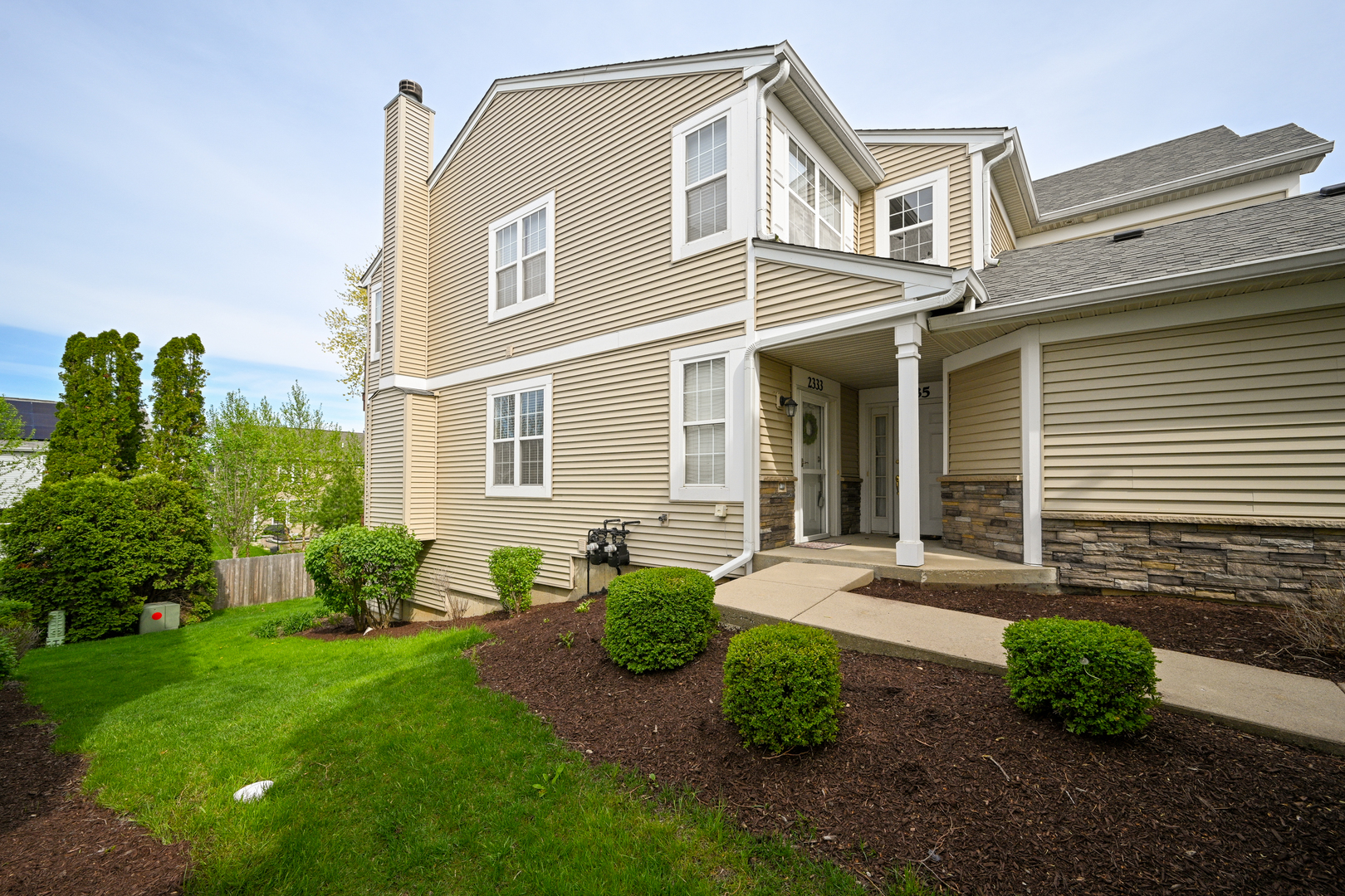 2333 Overlook Court, Unit 2333 Naperville, IL 60563 - Photo 2 of 24 a front view of a house with garden