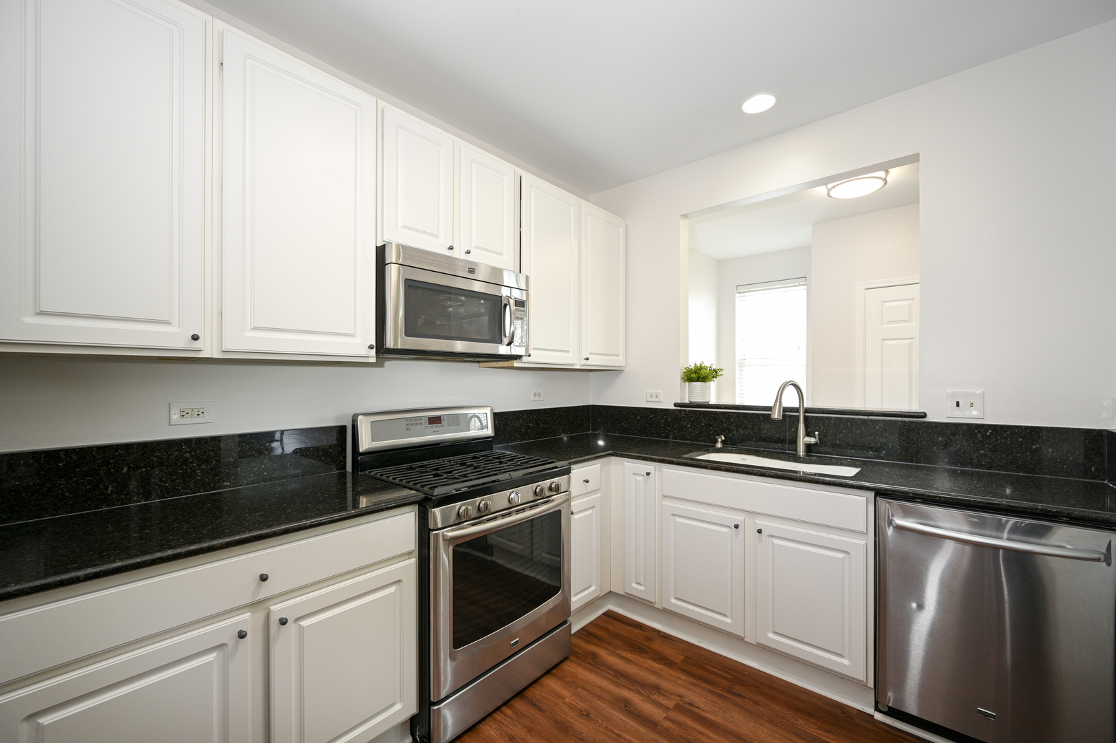 2333 Overlook Court, Unit 2333 Naperville, IL 60563 - Photo 8 of 24 a white kitchen with granite countertop a sink and cabinets
