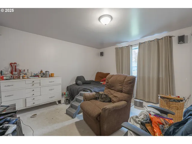 a kitchen with stainless steel appliances wooden floor and a refrigerator