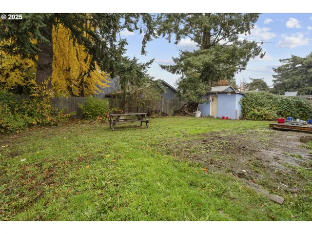 a backyard of a house with table and chairs