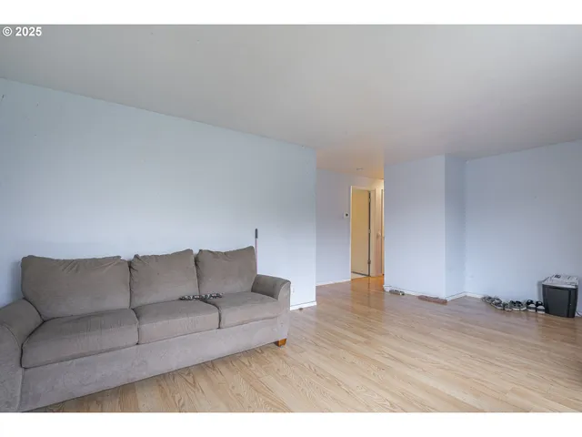 a spacious bedroom with a large bed and a large window