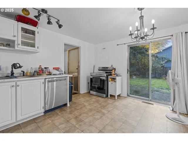 a kitchen with a refrigerator and cabinets