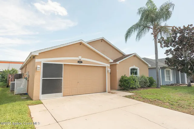a view of backyard of garage and a yard
