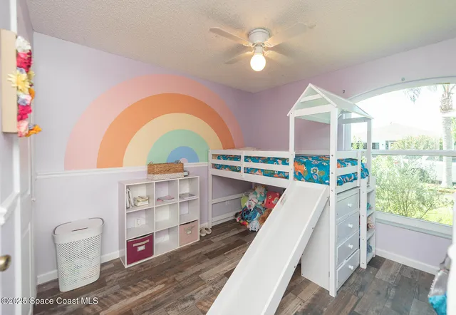 a view of living room with furniture and a floor to ceiling window