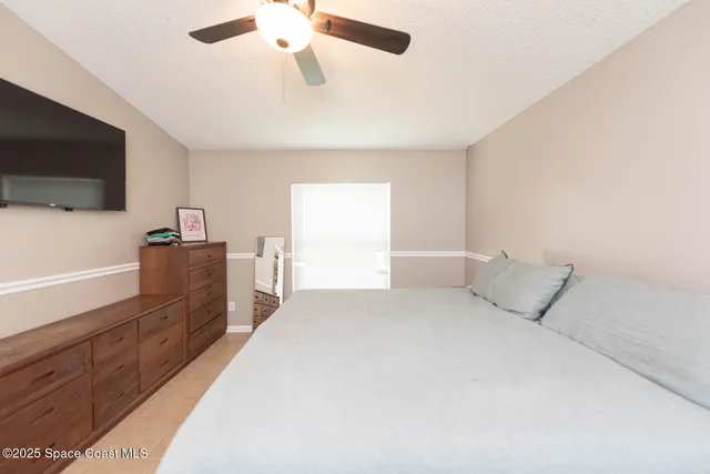 a bedroom with a bed and flat screen tv