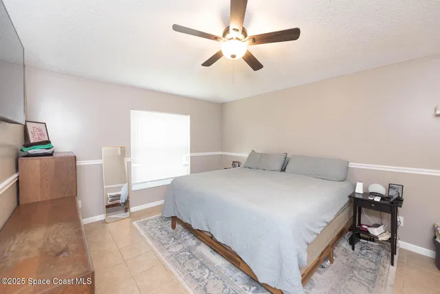 a spacious bedroom with a bed and a table in it