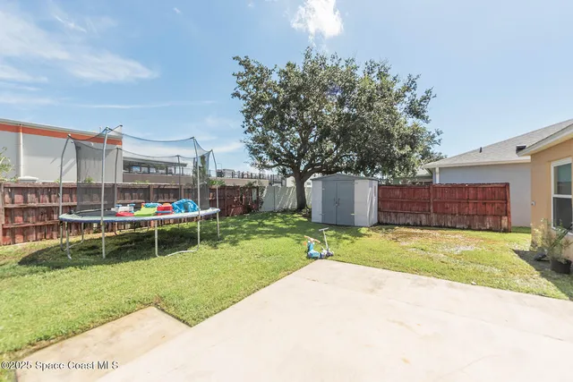 a backyard of a house with yard and outdoor seating